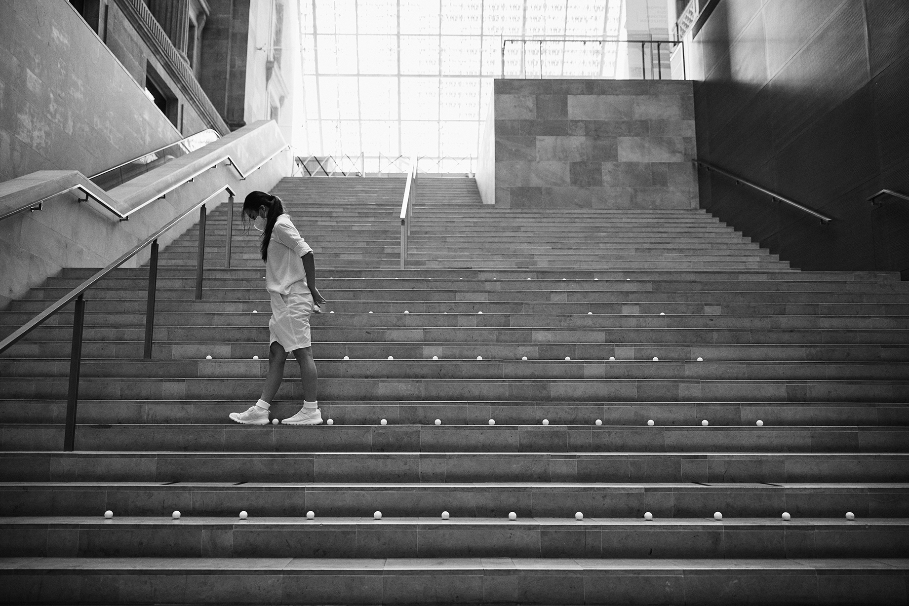 Dancer threads through ping pong balls spaced exactly a foot apart.